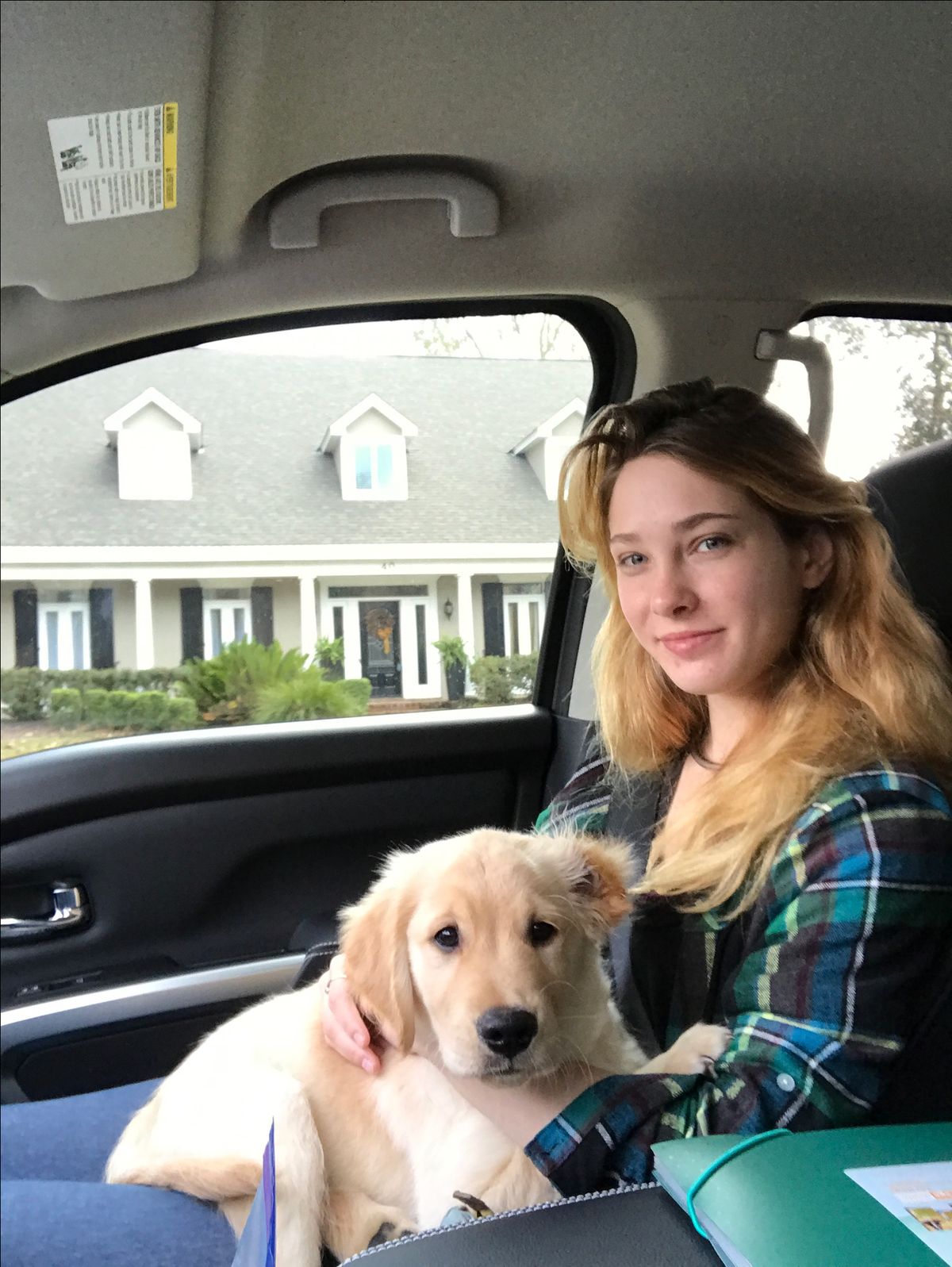 Lisa and family outdoors with their Golden Retriever